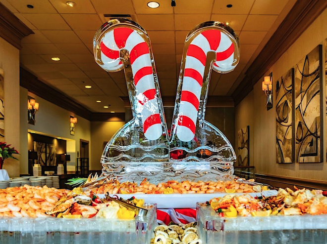 A seafood spread with an ice sculpture with candy canes. 